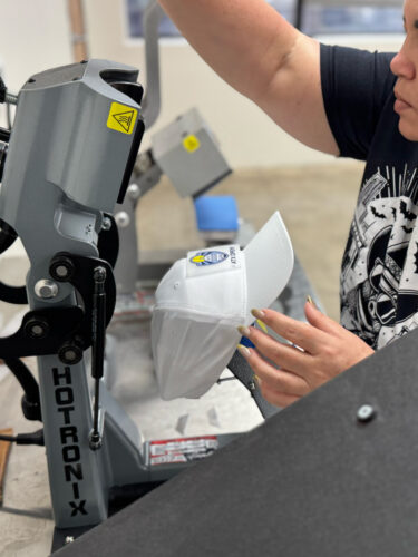 DTF transfer being applied by heat press.